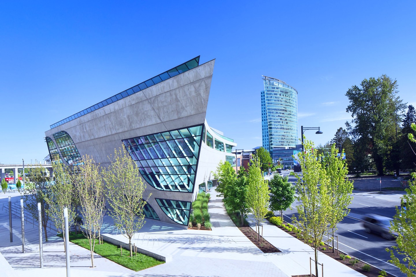 Modern glass building and trees in Surrey, B.C.
