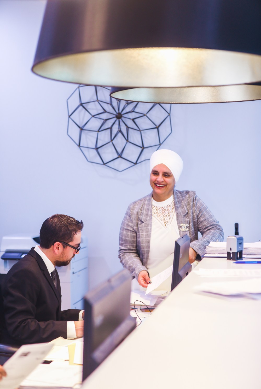 Lawyer meeting with a client at the front desk